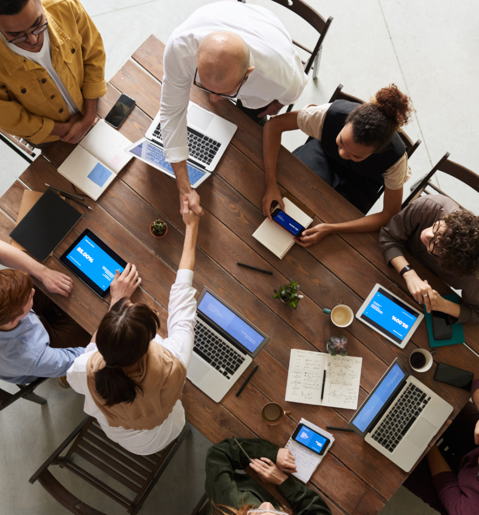 Team handshake during a business acquisition strategy meeting.