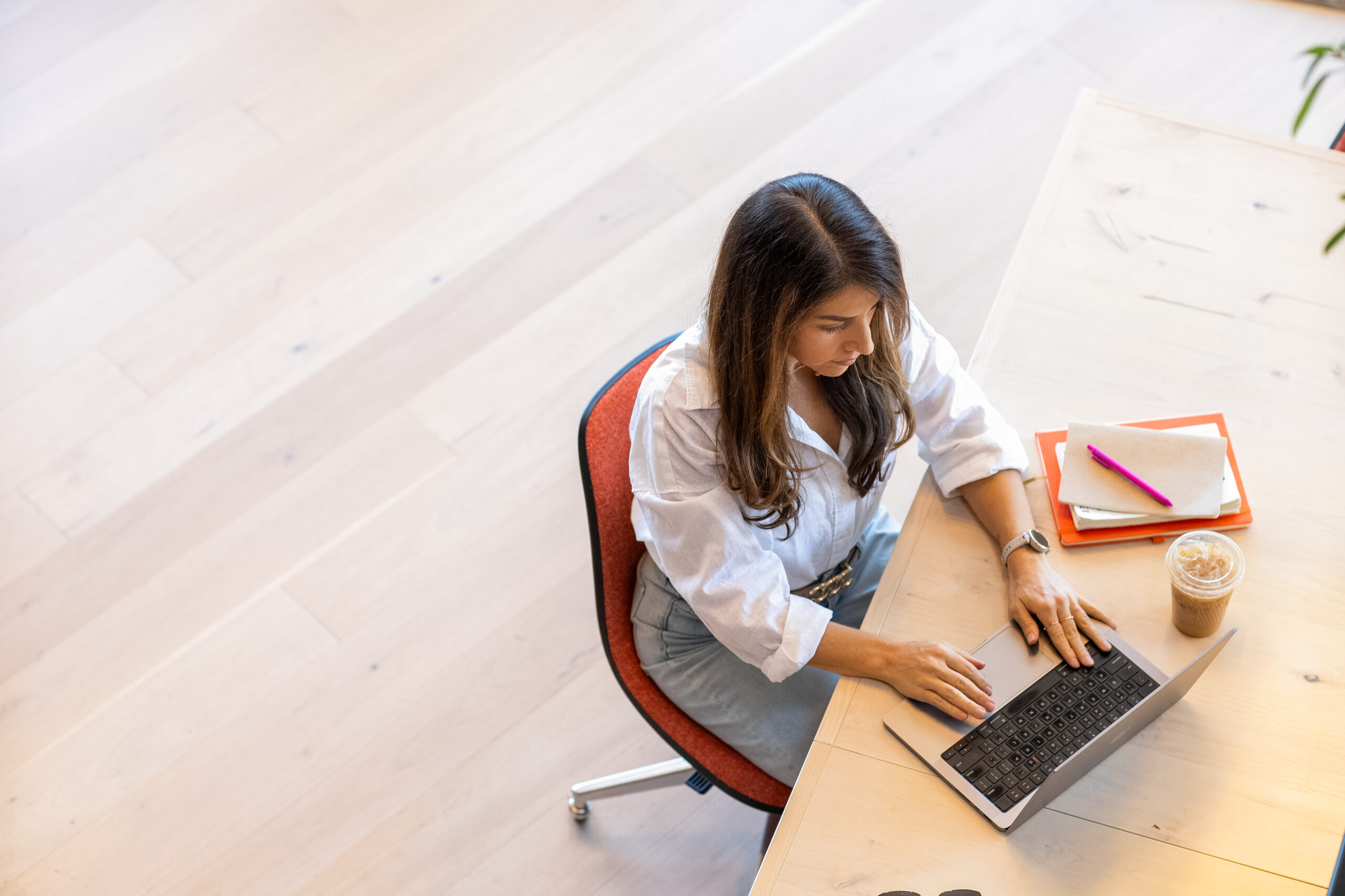 A founder working on a laptop at a desk, reflecting founder hiring decisions for a growing business.
