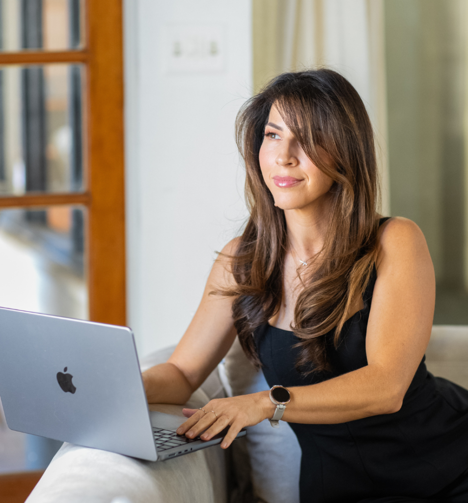 Founder working on a laptop in a bright office setting, representing a founder-led business.