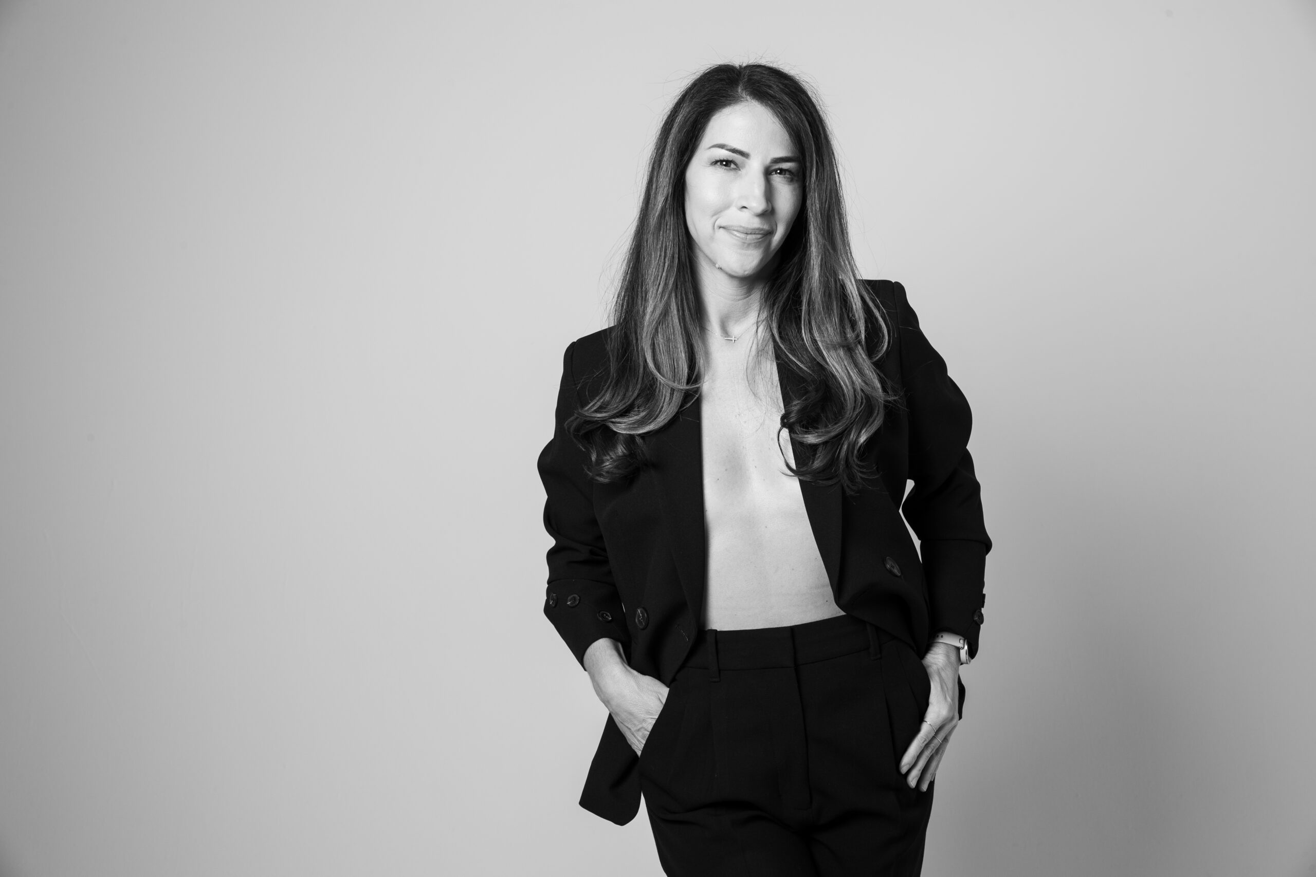 Black-and-white portrait of a business founder in a suit, representing confident leadership and founder operations.