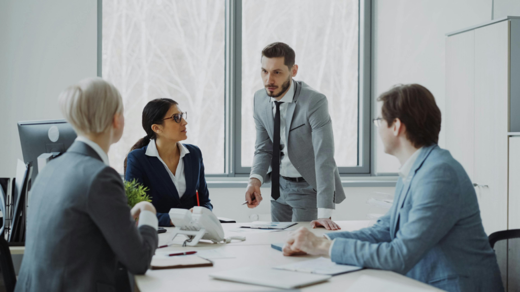 Business team relying on a central leader during a meeting, illustrating founder dependency in business.