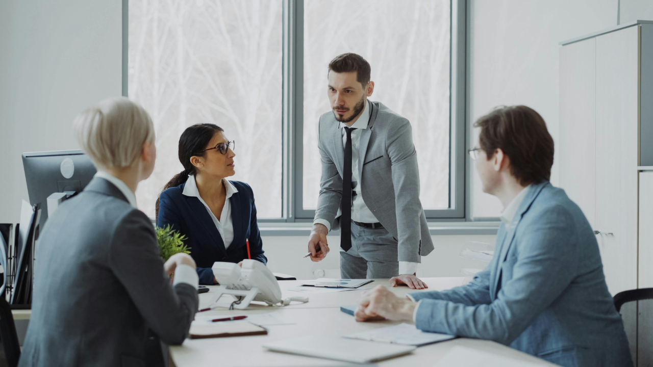 Business team relying on a central leader during a meeting, illustrating founder dependency in business.