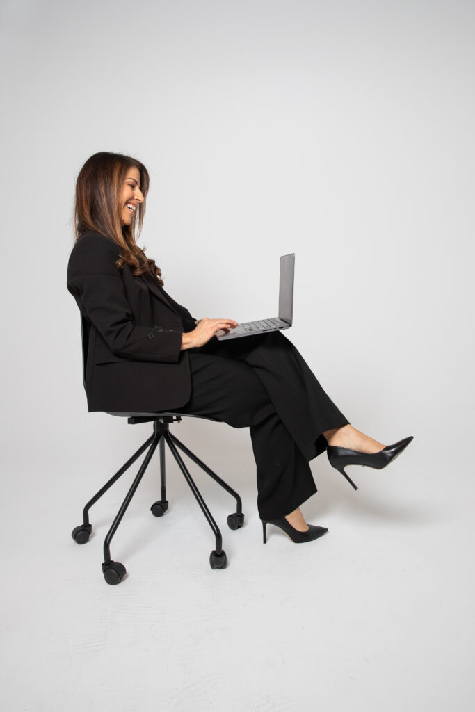 Businesswoman working on a laptop while managing lead ownership and sales follow-up responsibilities.