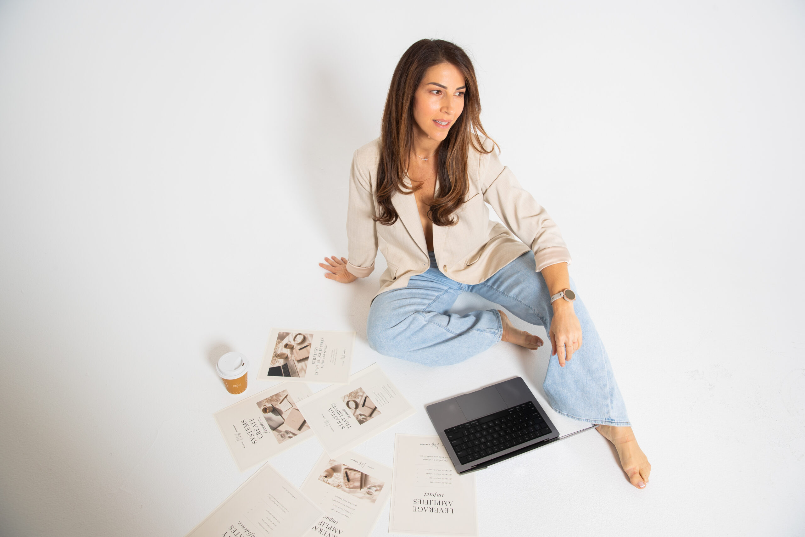 Business strategist seated beside a laptop and planning materials while working on sales opportunity management.