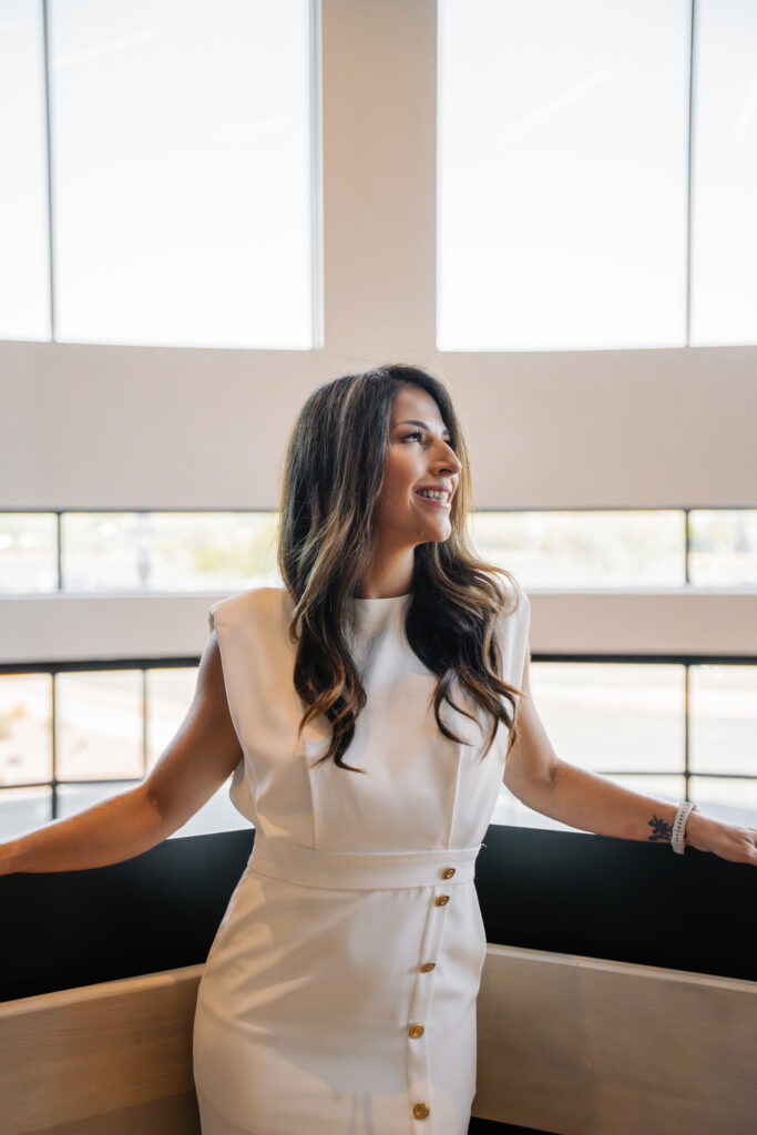 Business growth strategist standing in a bright office, representing confident leadership and an effective sales pipeline structure.