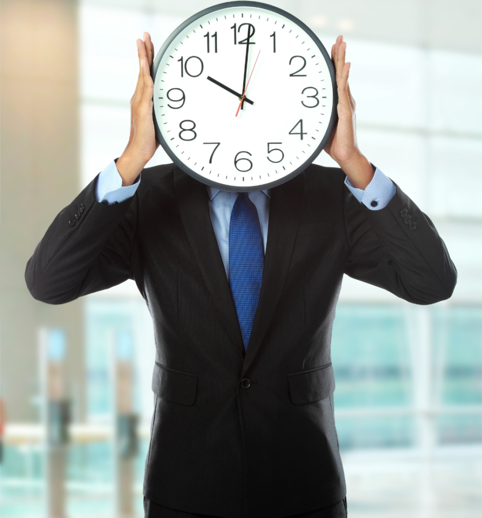 A business professional holds a large clock in front of their face, symbolizing founder time management and the challenge of balancing priorities, responsibilities, and limited time.