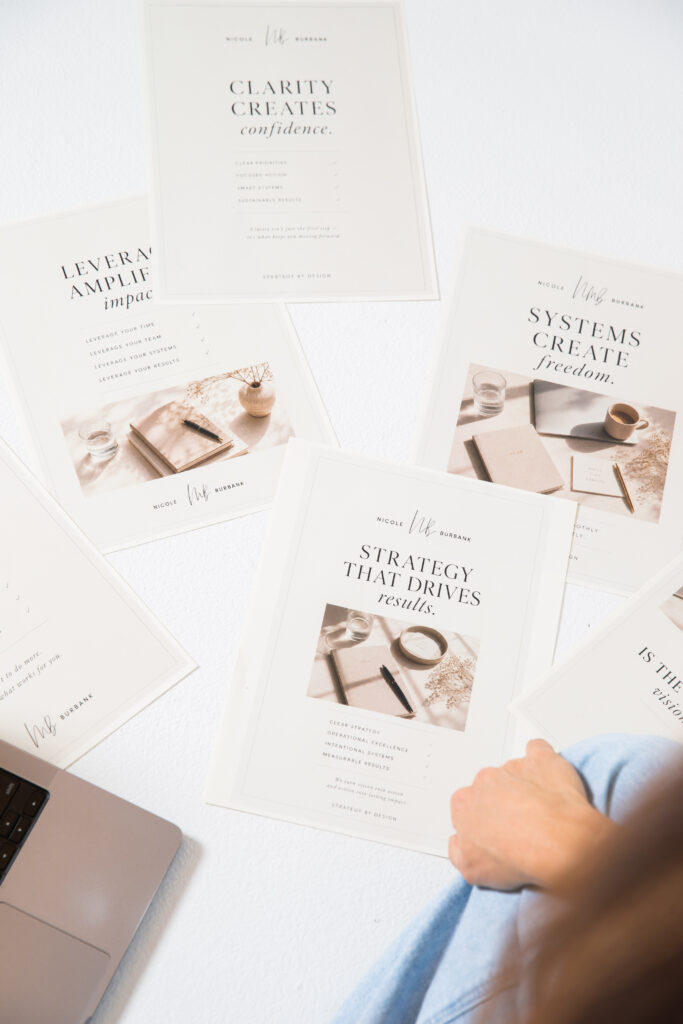Printed strategy and business planning materials illustrating the difference between SOPs vs systems in business operations.
